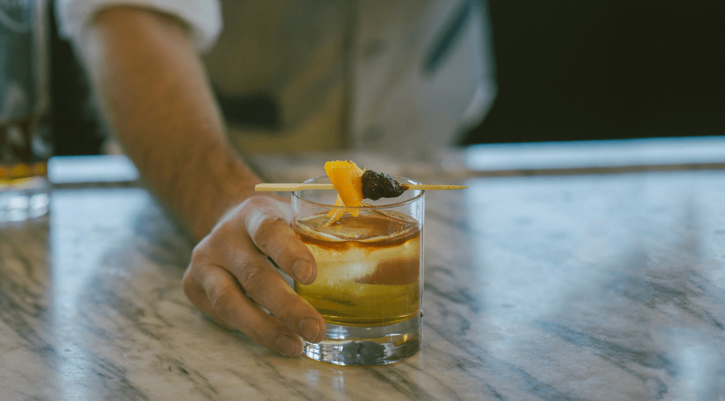 Bartender presenting a well prepared cocktail